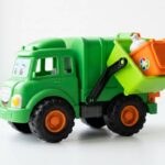 Garbage truck ride on toys including a colorful green toy truck with a working dump bin and recycling accessories