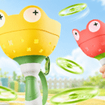 Manual capture catching game with frog-shaped launchers and green flying discs on a bright playful outdoor background.