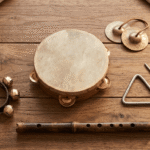 Stoie's wooden music set instruments including tambourine triangle bells and flute on a wood surface