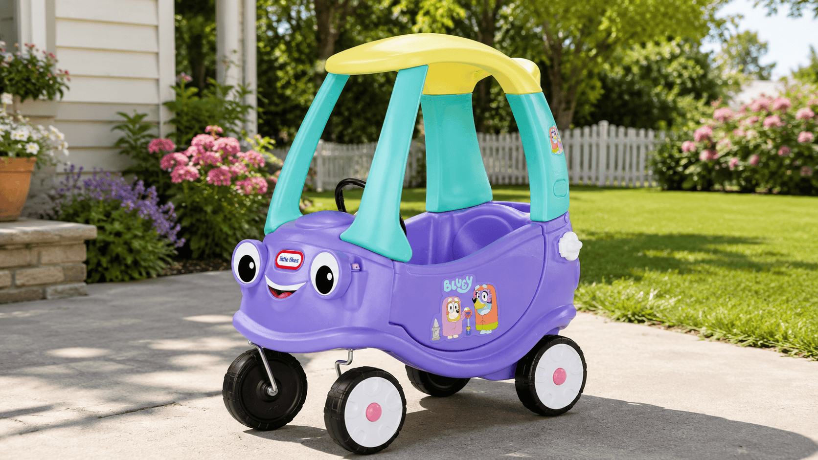 Little Tikes Bluey Grannies Car Coupe on a sunny driveway beside a backyard