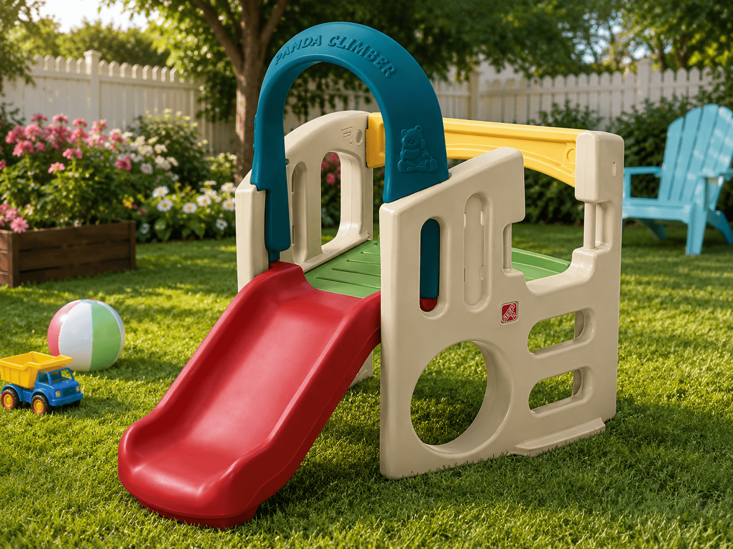 Step2 Panda Climber set up in a sunny backyard with a red slide, green grass, colorful flowers, and outdoor toys